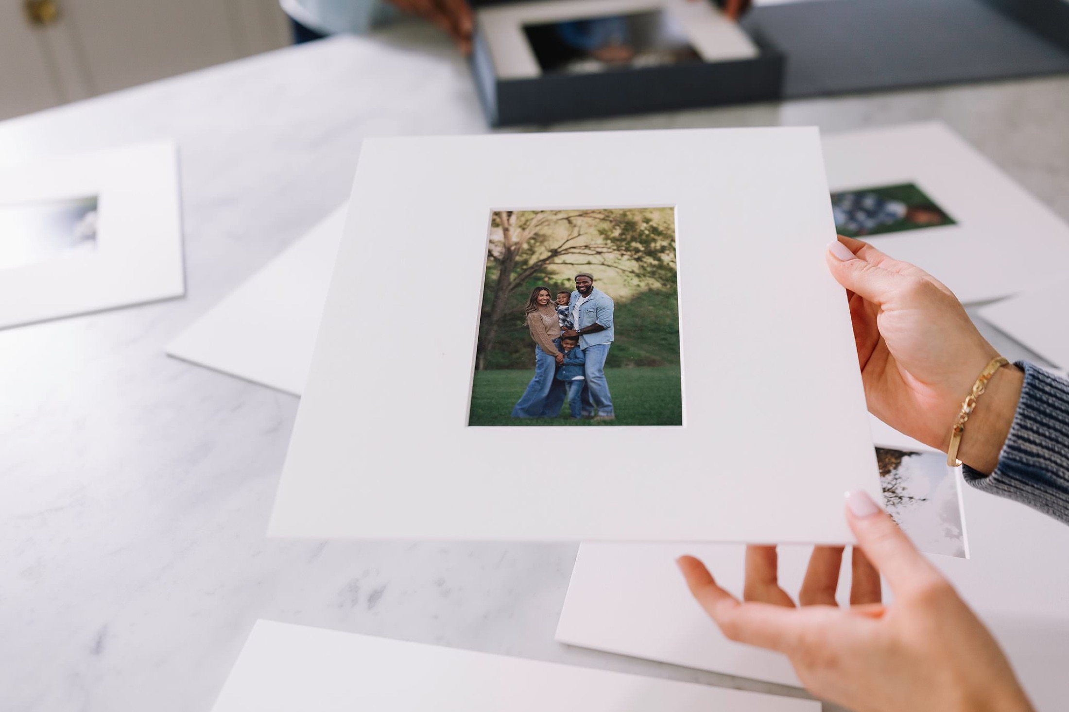 Hands holding a museum-grade matted print