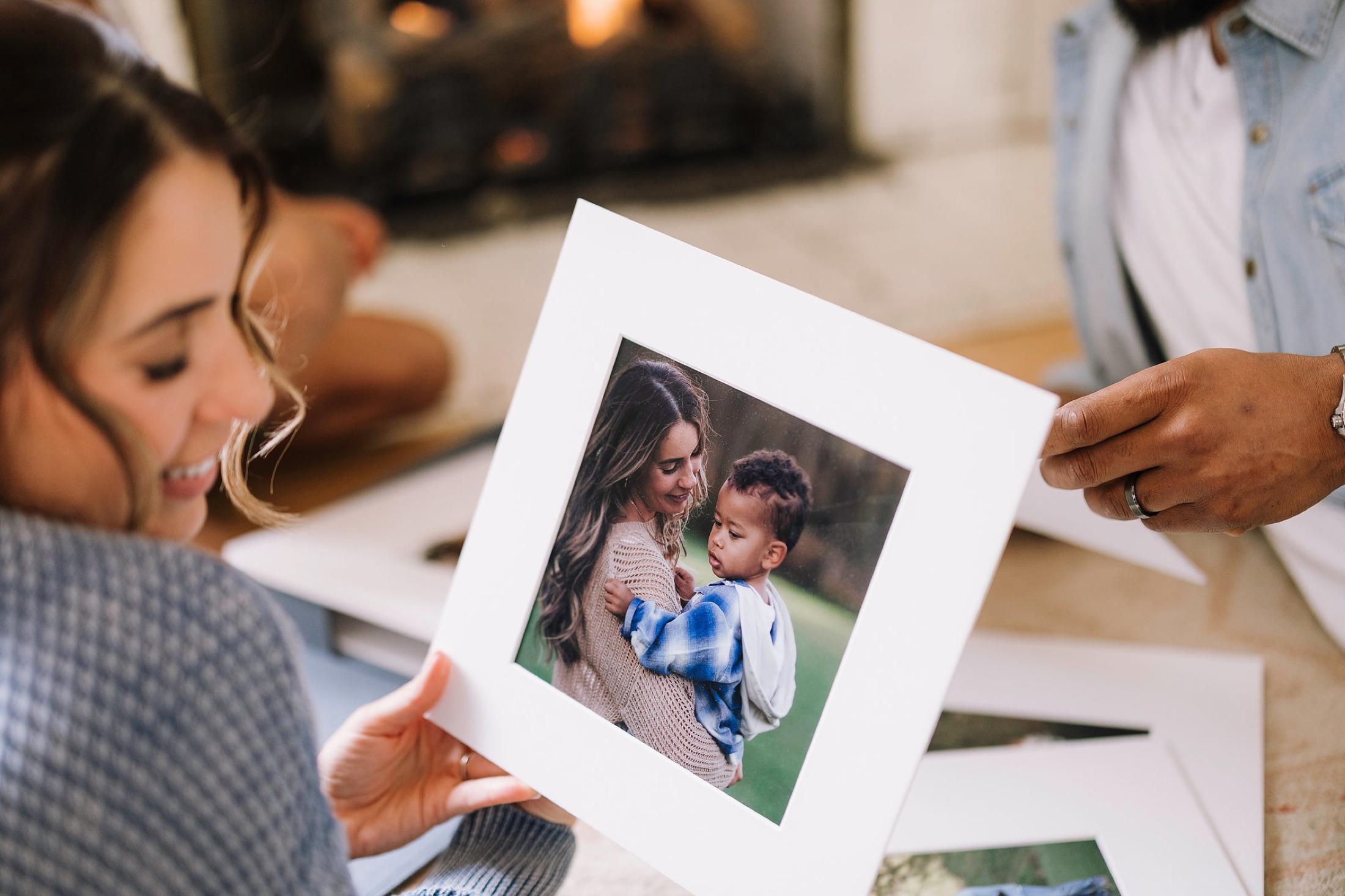 A mother holding a matted print of her with her son