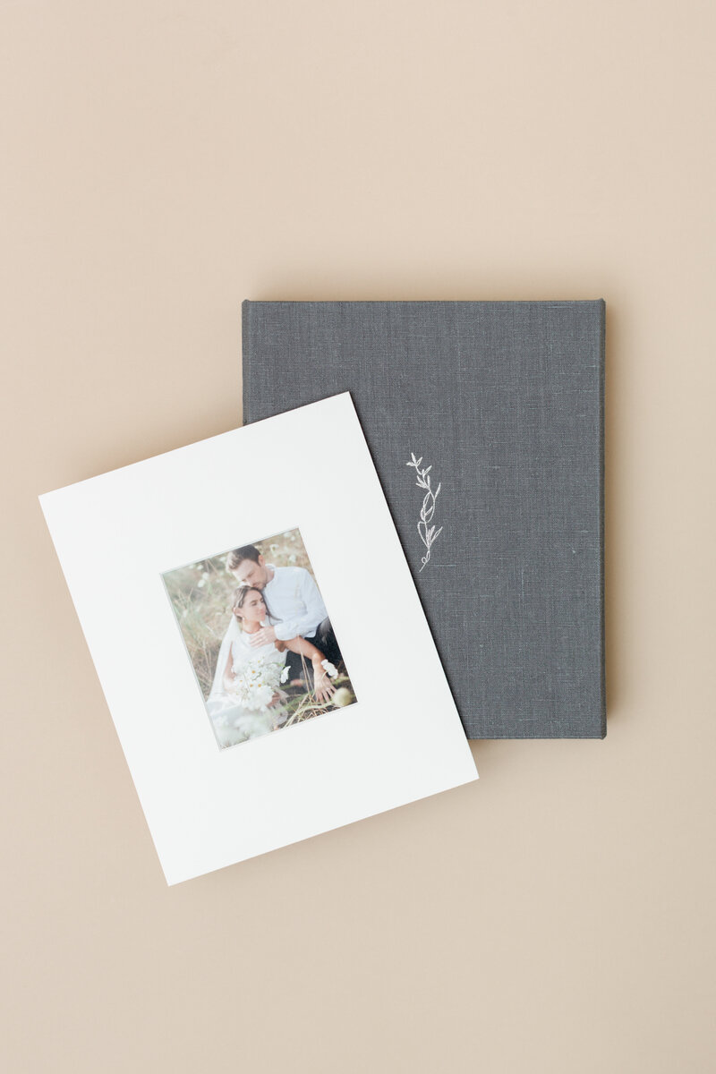 Stone linen matted print box with a stack of matted prints on top
