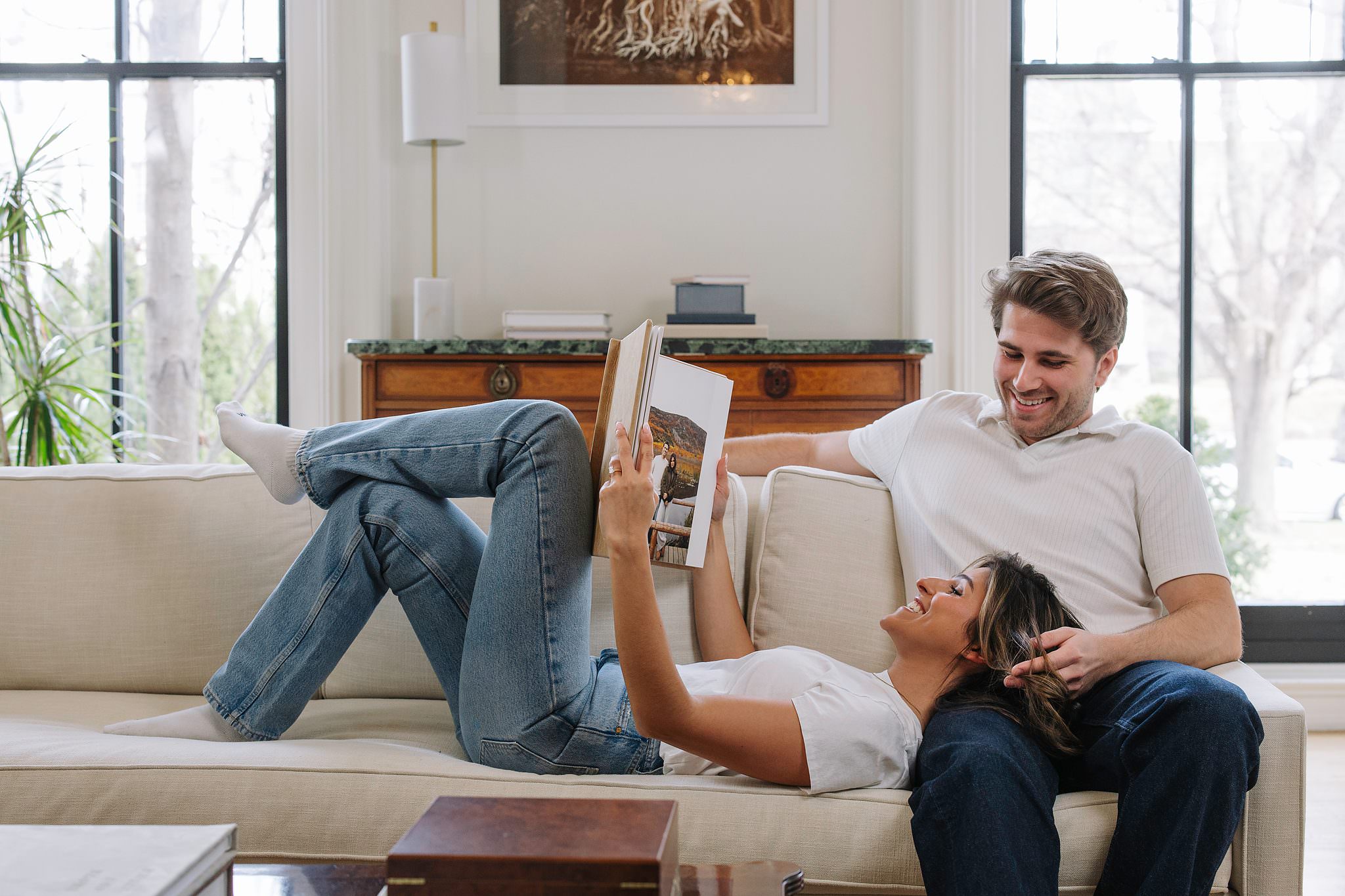 A couple reading their RedTree Album together on the couch