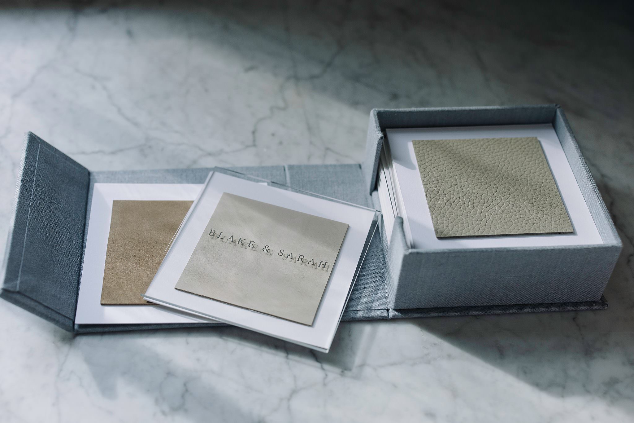 A fabric wrapped custom swatch kit open on a studio table